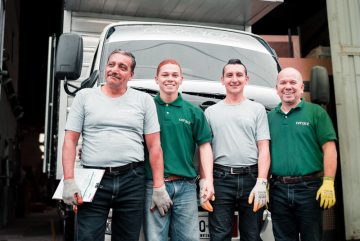 Canva - 4 Men Standing Near White Van
