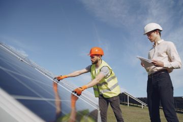Canva - Technician and manager checking equipment for solar energy station